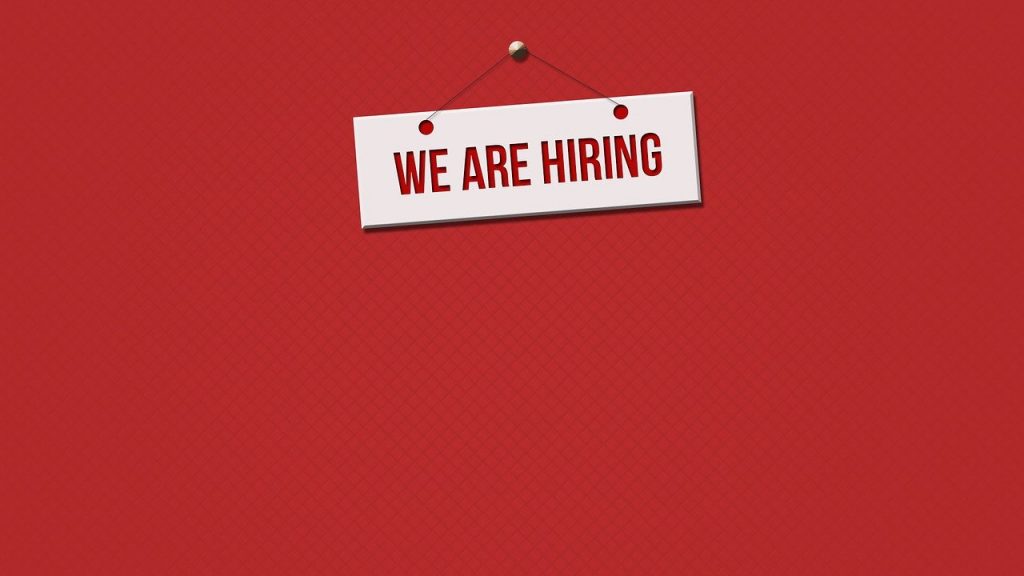 We are hiring sign on red background