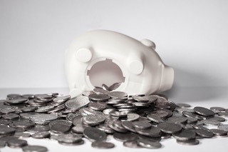 Open white piggy bank with coins