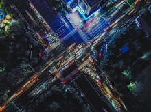 Drone Point View of City Street Crossing at Rush Hour, Long Exposure