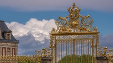 Golden gates to estate with clouds in background