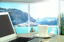 Laptop and coffee cup with view