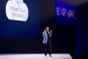 Paul Turner speaking on stage at VMware Explore about VMware Cloud Foundation - VCF