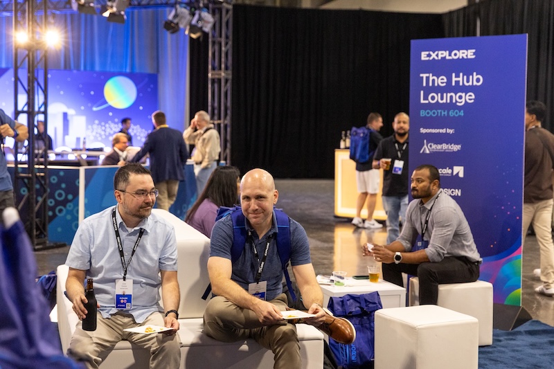 Attendees in The Hub Lounge at VMware Explore 2025 in Las Vegas.