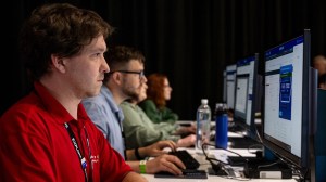 Attendees sitting at HOL computers getting trained at VMware Explore.